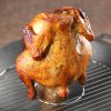 Grilled beer can chicken in pan on table